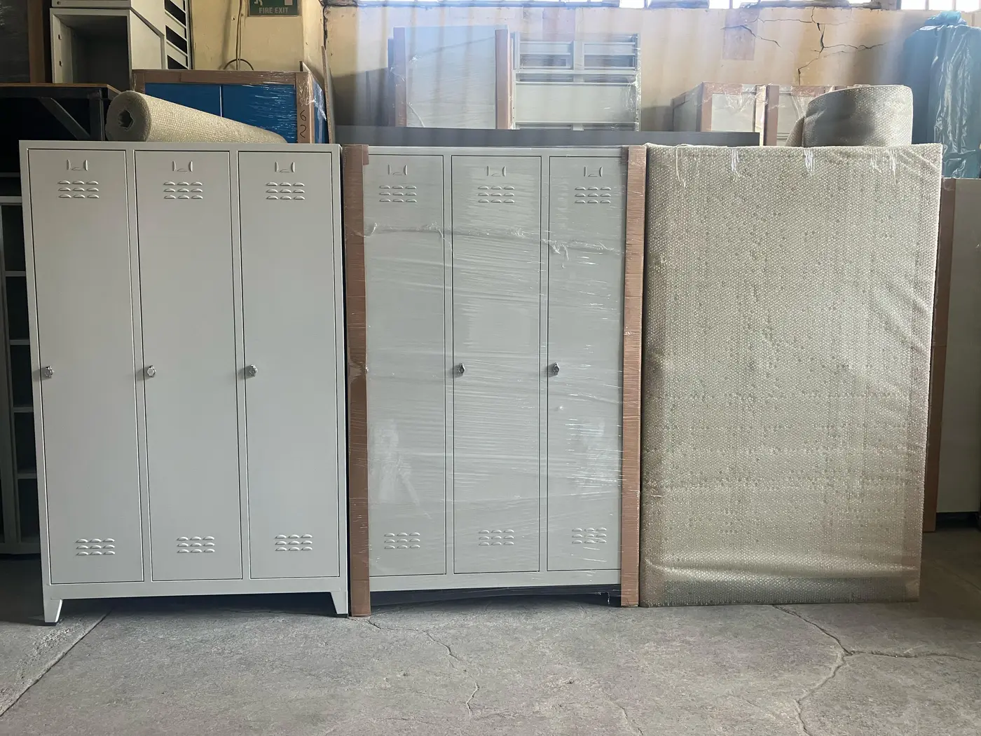Steel lockers packed for export in three stages, bare, stretch-wrapped, then bubble-wrapped
